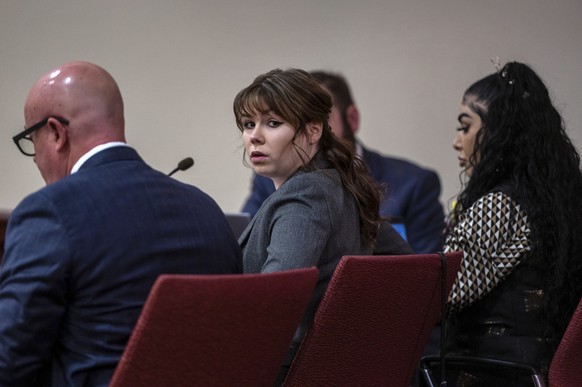 Hannah Gutierrez-Reed, center, sits with her attorney Jason Bowles, left, during the first day of testimony in the trial against her in First District Court, in Santa Fe, N.M., Thursday, February 22,  ...