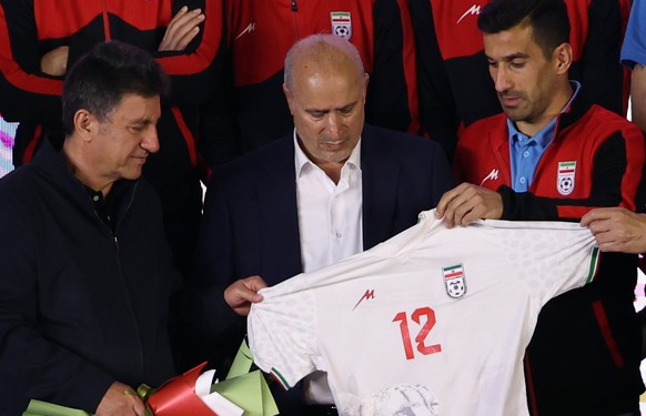 epa12954515 Head of the Iranian soccer federation Mehdi Taj (C) holds Iran's national team jersey for the World Cup during a farewell ceremony in Tehran, Iran, 13 May 2026. Iran's national t ...