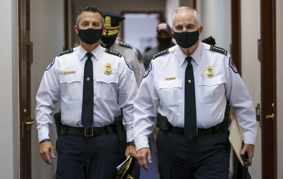 Acting Assistant Chief for Uniformed Operations Sean Gallagher, left, and U.S. Capitol Police Chief Tom Manger, right, arrive for a news conference to discuss preparations for a weekend rally planned  ...