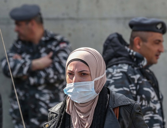 epa08255627 An anti-government protester wears a face mask during a protest in front of the Lebanese Ministry of Health under the slogan &#039;Our life is not a toy in your hands&#039; in Beirut, Leba ...