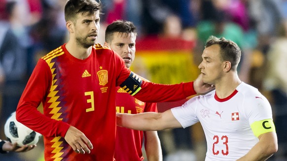 Spain&#039;s forward Rodrigo Moreno, Spain&#039;s forward Saul Niguez, and Spain&#039;s defender Gerard Pique, from left to right, react next to Switzerland&#039;s midfielder Xherdan Shaqiri, right, d ...