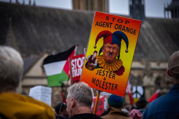 September 17, 2025, London, England, United Kingdom: A protestor holds a placard during the Trump not welcome demonstration at Parliament Square. Around 50 protest groups were expected to gather toget ...