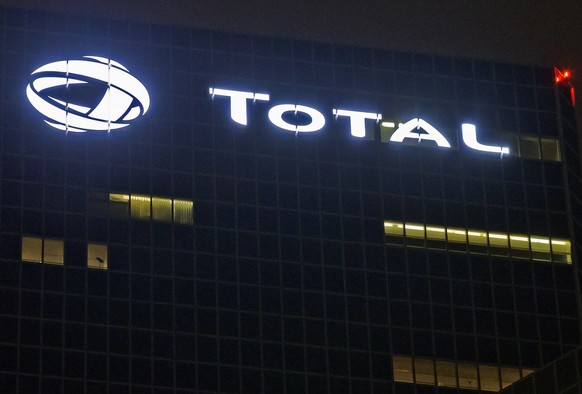 FILE - In this Oct. 12, 2016, file photo, the logo of French oil giant Total SA is pictured at company headquarters in La Defense business district, outside Paris. French energy giant Total signed meg ...