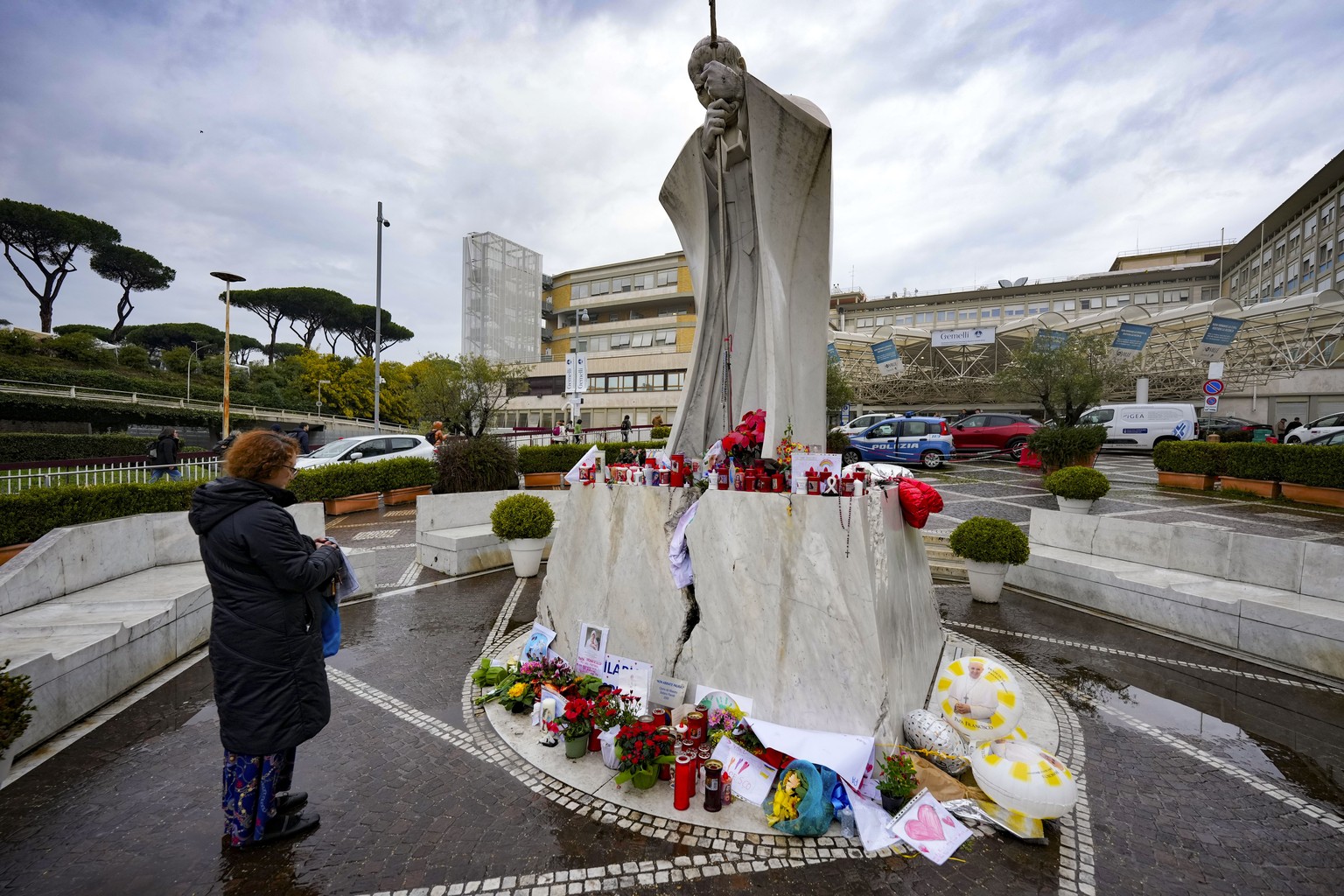 A woman prays for Pope Francis in front of the Agostino Gemelli Polyclinic, in Rome, where the Pontiff has been hospitalized since Feb. 14, Wednesday, Feb. 26, 2025. (AP Photo/Andrew Medichini)
