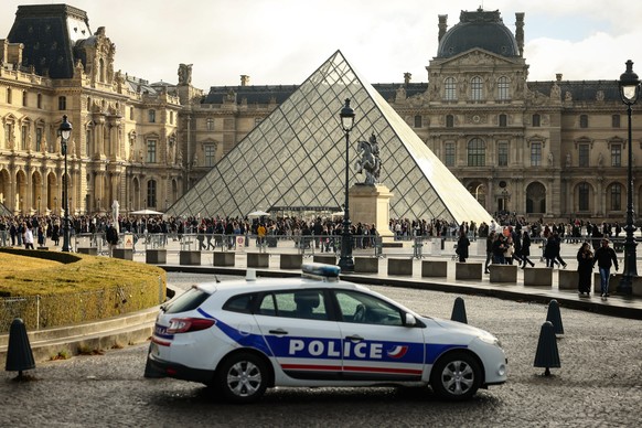 FILE - A police car parks in the courtyard of the Louvre museum, one week after the robbery, on Oct. 26, 2025, in Paris. (AP Photo/Thomas Padilla, File)
France-Louvre Robbery