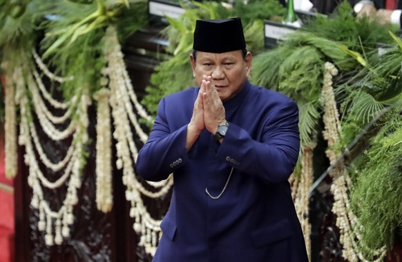 epa11670500 Indonesia?s newly inaugurated President Prabowo Subianto greets the parliament members during the inauguration ceremony at the Parliamentary Building in Jakarta, Indonesia, 20 October 2024 ...