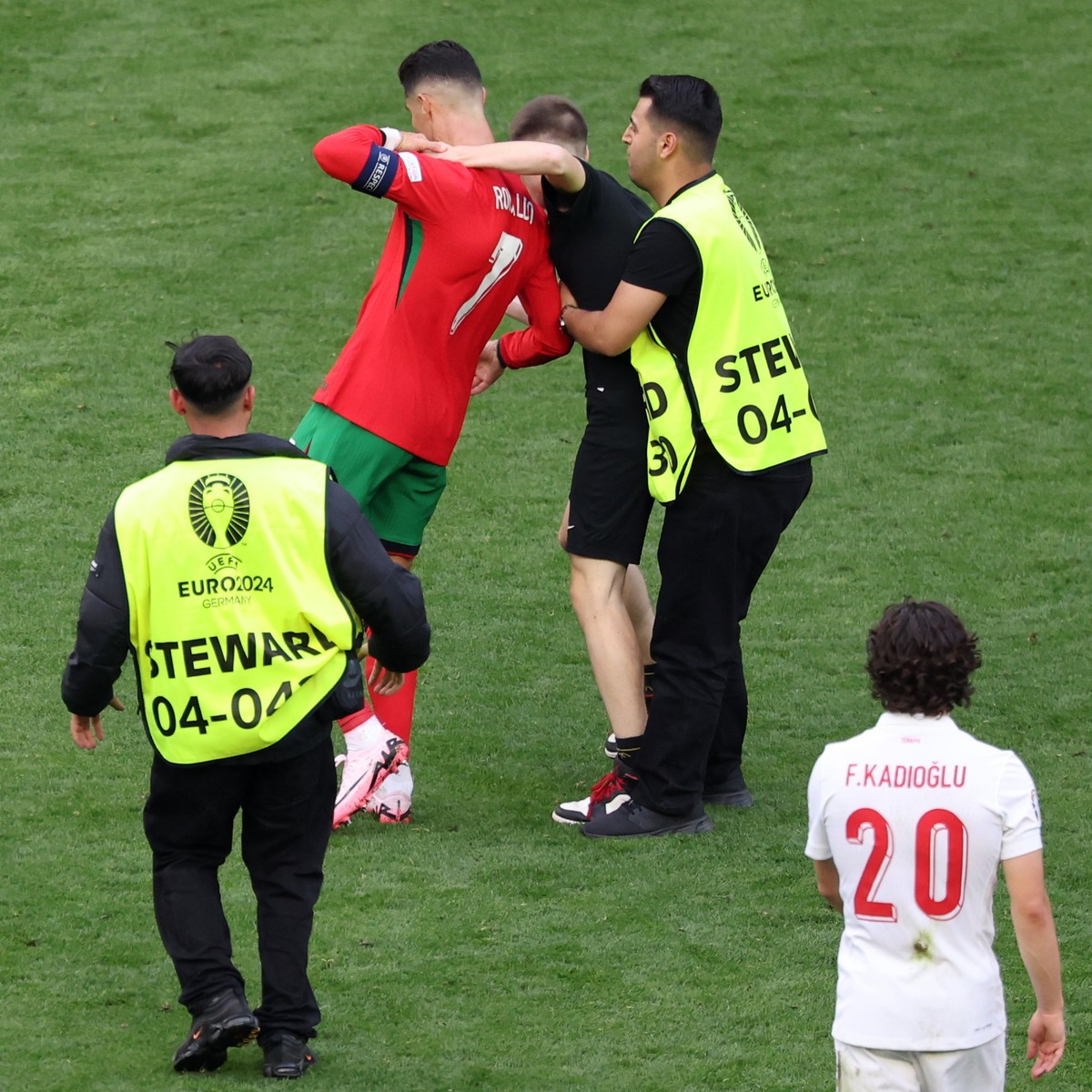 epa11430990 A pitch invader attempts to take a picture with Cristiano Ronaldo of Portugal during the UEFA EURO 2024 group F soccer match between Turkey and Portugal, in Dortmund, Germany, 22 June 2024 ...