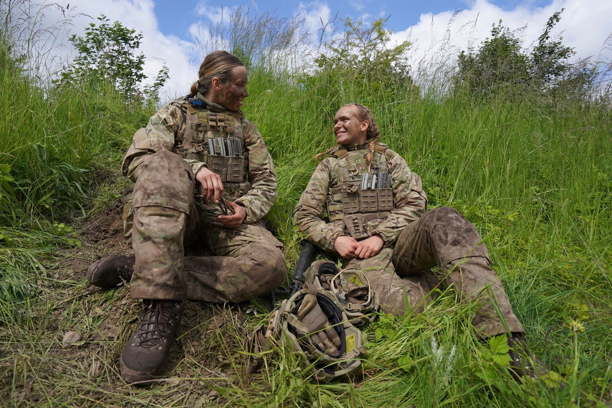 20-year-old conscript Katrine, right, speaks with another female conscript during final exercises at a training area close to Royal Danish Army's barracks in Hovelte, 25 kilometres north of Copen ...