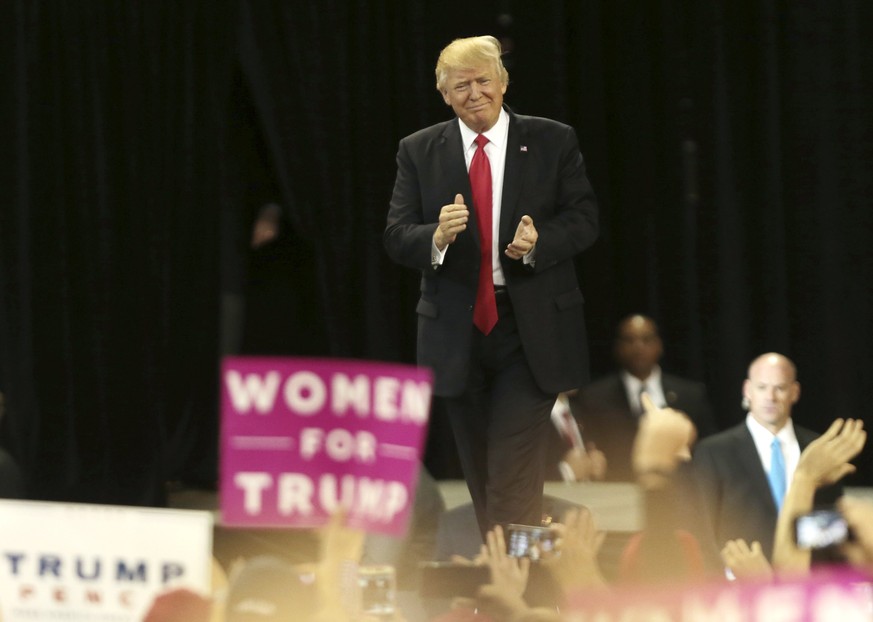 epa05860847 US President Donald J. Trump applauds as he arrives to a rally at the Kentucky Exposition Center in Louisville, Kentucky, USA, 20 March 2017. Trump is appearing at several Make America Gre ...