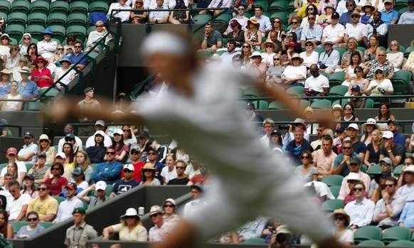 epa07687514 Spectators watch Alexander Zverev of Germany return to Jiri Vesely of the Czech Republic in their first round match during the Wimbledon Championships at the All England Lawn Tennis Club, ...