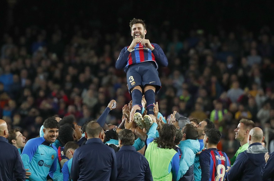 Barcelona's Gerard Pique, center up, is thrown in the air by players of Barcelona after the Spanish La Liga soccer match between Barcelona and Almeria at the Camp Nou stadium in Barcelona, Spain, Satu ...