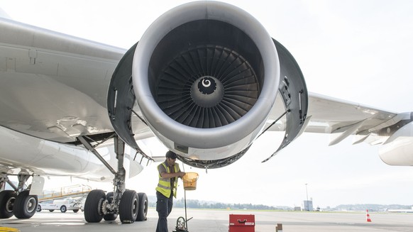 Maintenance of Swiss International Air Lines airplanes at Zurich Airport in Kloten in the Canton of Zurich, Switzerland, pictured on July 24, 2014. An employee changes the fuel filter of an airplane e ...