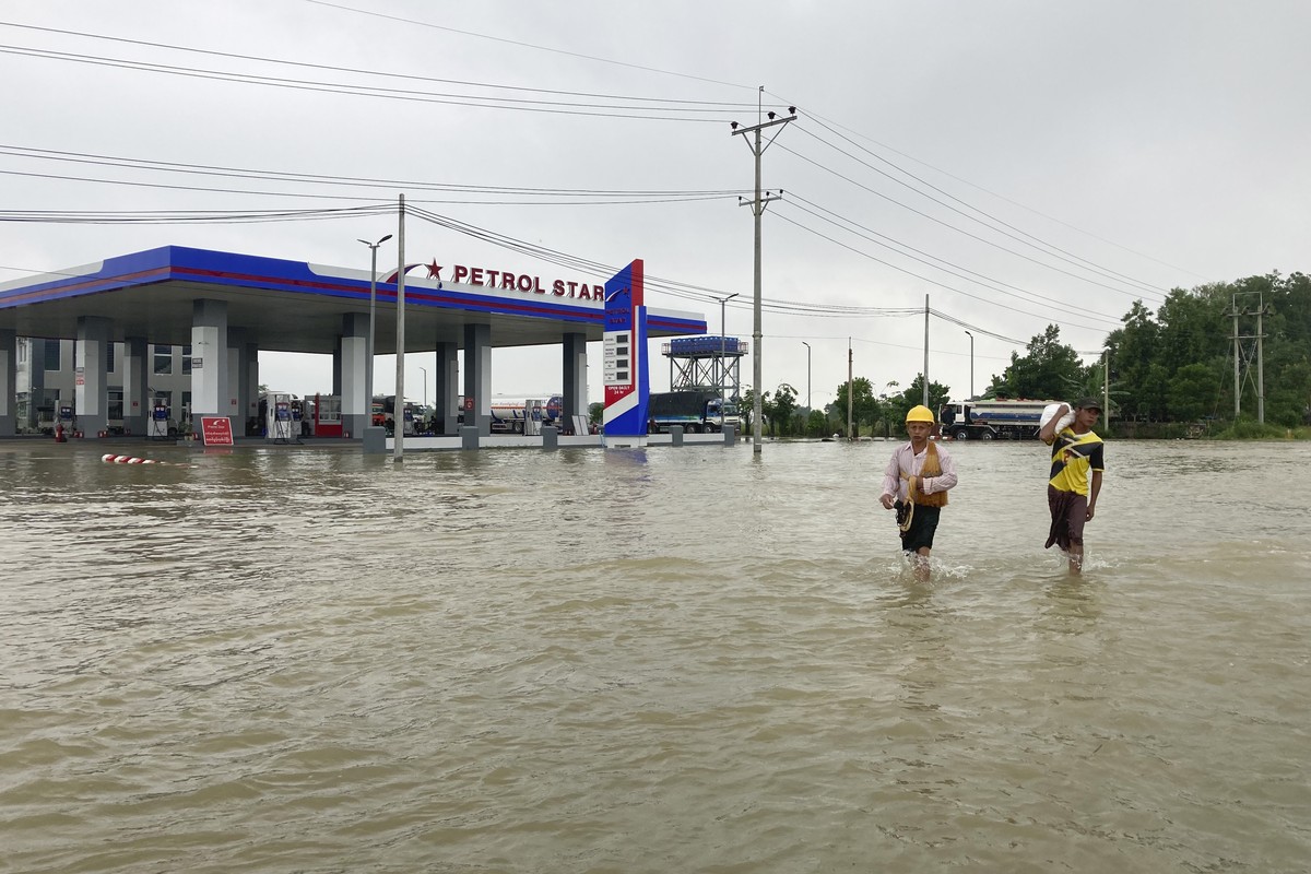 Local residents wade through a flooded road in Bago, about 80 kilometers (50 miles) northeast of Yangon, Myanmar, Monday, Oct. 9, 2023. Flooding triggered by heavy monsoon rains in Myanmar?s southern  ...