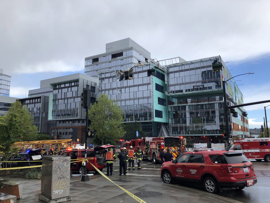 epa07533245 A handout photo made available by the Seattle Fire Department shows emergency services workers at the scene of a construction crane collapse in Seattle, Washington, USA, 27 April 2019 (iss ...