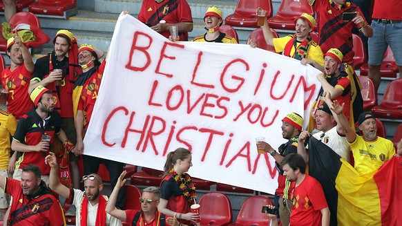 epa09280065 Belgium fans hold a sign for Denmark&#039;s player Christian Eriksen prior to the UEFA EURO 2020 group B preliminary round soccer match between Denmark and Belgium in Copenhagen, Denmark,  ...