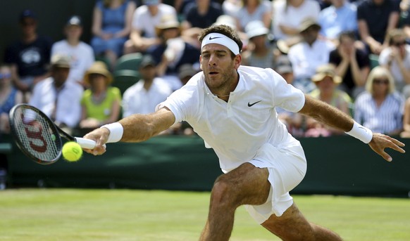 Argentina&#039;s Juan Martin Del Potro returns the ball to Latvia&#039;s Ernests Gulbis during their Men&#039;s Singles Match at the Wimbledon Tennis Championships in London Thursday, July 6, 2017. (G ...
