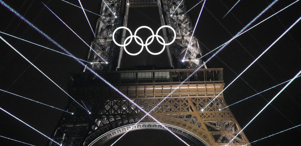FILE -A light show is projected from the Eiffel Tower in Paris, France, during the opening ceremony of the 2024 Summer Olympics, July 26, 2024. (AP Photo/David J. Phillip, File)