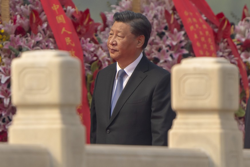 Chinese President Xi Jinping walks past floral bouquets during a ceremony to mark Martyr&#039;s Day at the Monument to the People&#039;s Heroes at Tiananmen Square in Beijing, Friday, Sept. 30, 2022.  ...