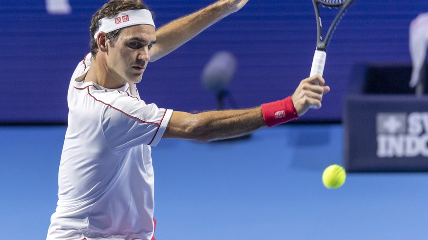 epa07943743 Switzerland&#039;s Roger Federer returns a ball to Moldova&#039;s Radu Albot during their second round match at the Swiss Indoors tennis tournament at the St. Jakobshalle in Basel, Switzer ...