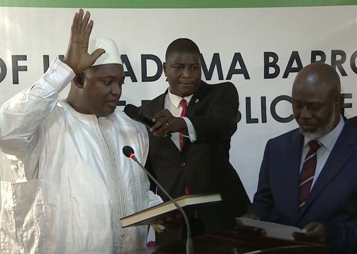 Adama Barrow, left, is sworn in as President of Gambia at Gambia's embassy in Dakar Senegal in this image taken from TV Thursday, Jan 19, 2017. A new Gambian president has been sworn into office  ...