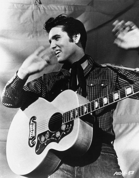 Elvis Presley poses with his Gibson J-200 guitar in an MGM studio publicity photo from the 1950s. Presley will be reunited with Sun Records as part of a licensing agreement between the owner of the hi ...