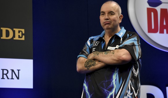 In this Oct. 21, 2017 photo Phil Taylor from England reacting to his defeat in the finals of the German Darts Masters 2017 in the Castello arena, in Duesseldorf, Germany. (Lisa Ducret/dpa via AP)