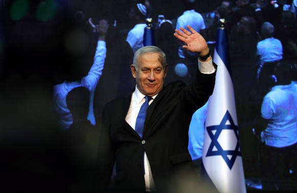 epaselect epa07849792 Benjamin Netanyahu (C), Israeli Prime Minister and Chairman of the Likud Party, greets supporters after early exit polls in the general election, at the Likud party final electio ...