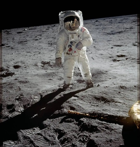 Astronaut Buzz Aldrin walks on the surface of the moon near the leg of the lunar module Eagle during the Apollo 11 mission. Mission commander Neil Armstrong took this photograph with a 70mm lunar surf ...