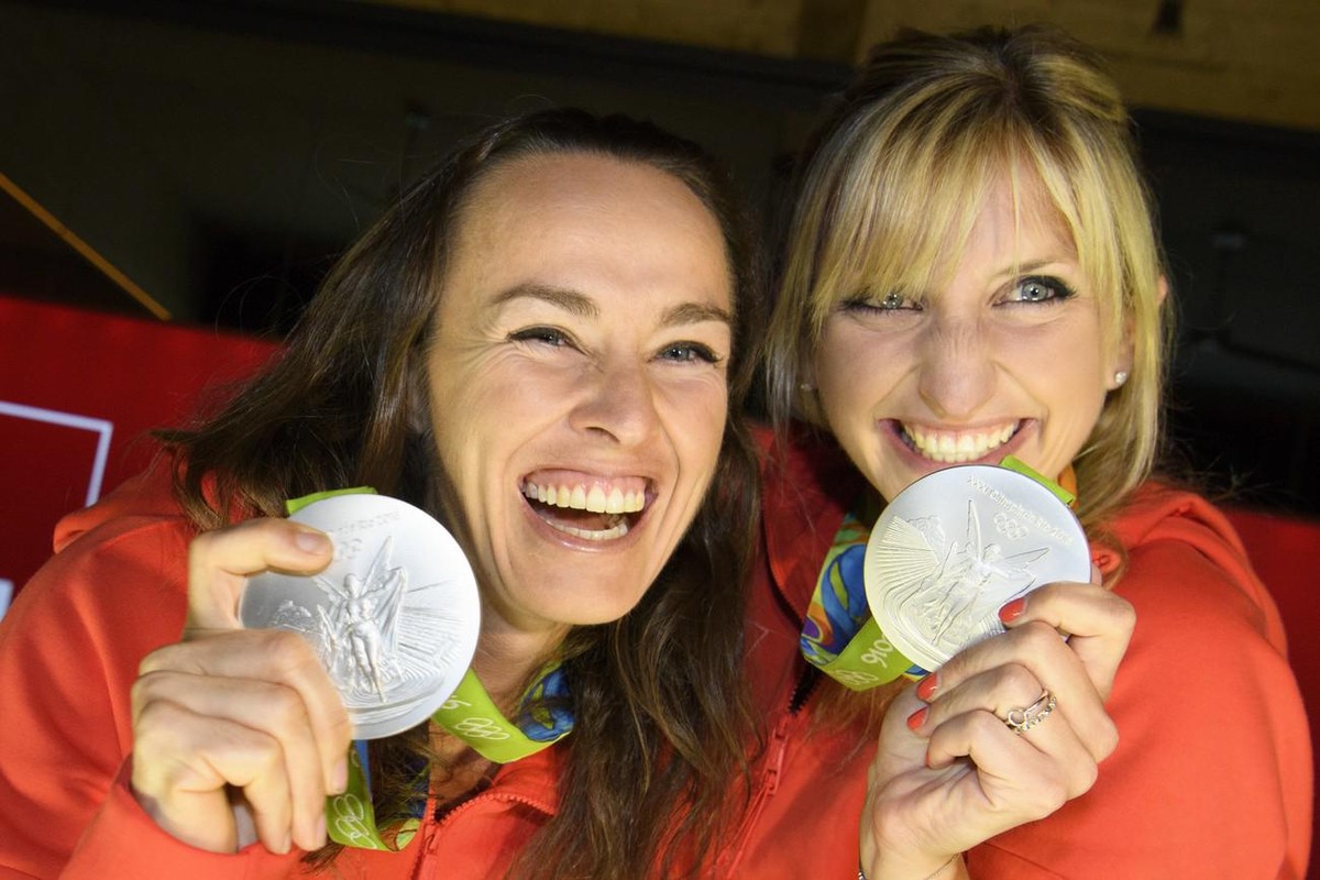 Timea Bacsinszky, right, and Martina Hingis, left, pose with their silver medal in the women's Tennis Doubles tournament during a medal celebration celebrating in the House of Switzerland at the  ...