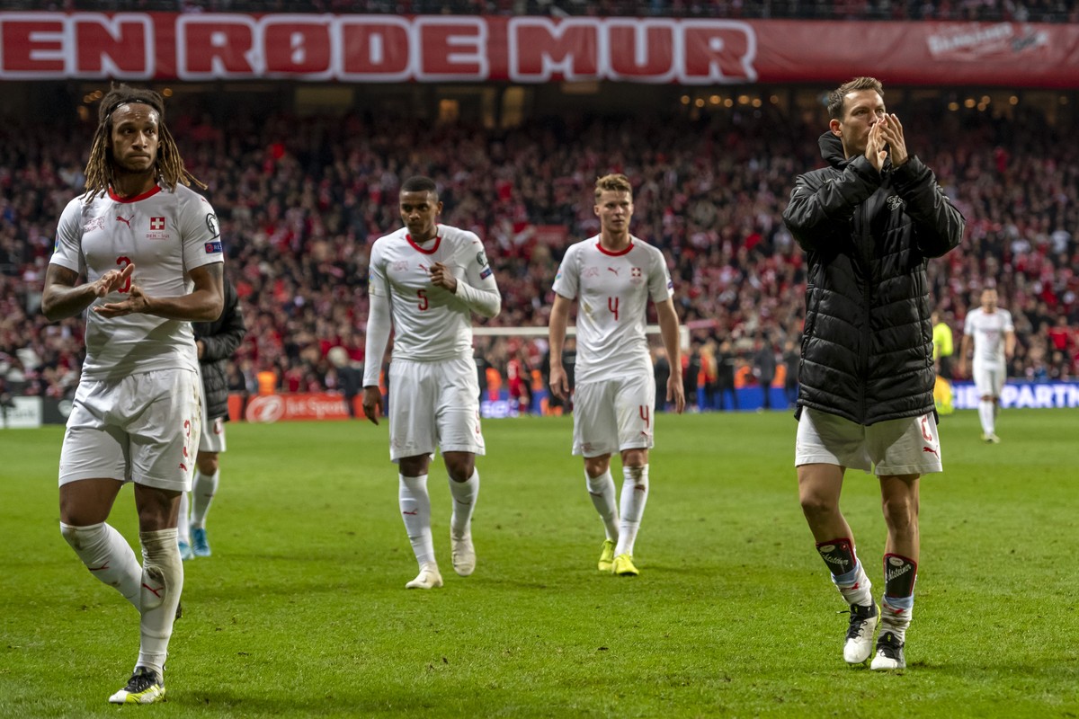 Switzerland's Kevin Mbabu, Manuel Akanji, Nico Elvedi and Stephan Lichtsteiner, from left, leave the pitch after the UEFA Euro 2020 qualifying Group D soccer match between Denmark and Switzerland ...