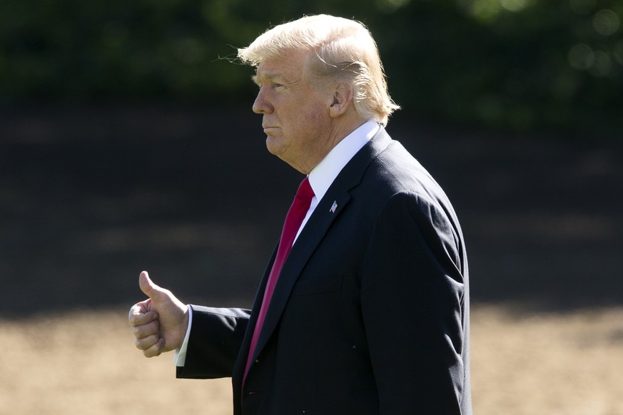 epa07089318 US President Donald J. Trump gestures as he walks across the South Lawn of the White House to depart by Marine One, in Washington, DC, USA, 12 October 2018. Trump travels to Ohio for a ral ...