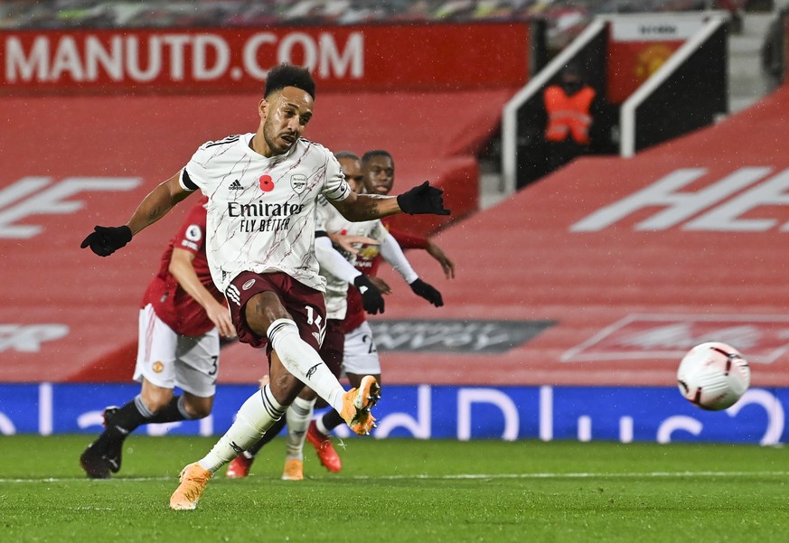 epa08791674 Pierre-Emerick Aubameyang of Arsenal scores from the penalty spot the 1-0 lead during the English Premier League soccer match between Manchester United and Arsenal FC in Manchester, Britai ...