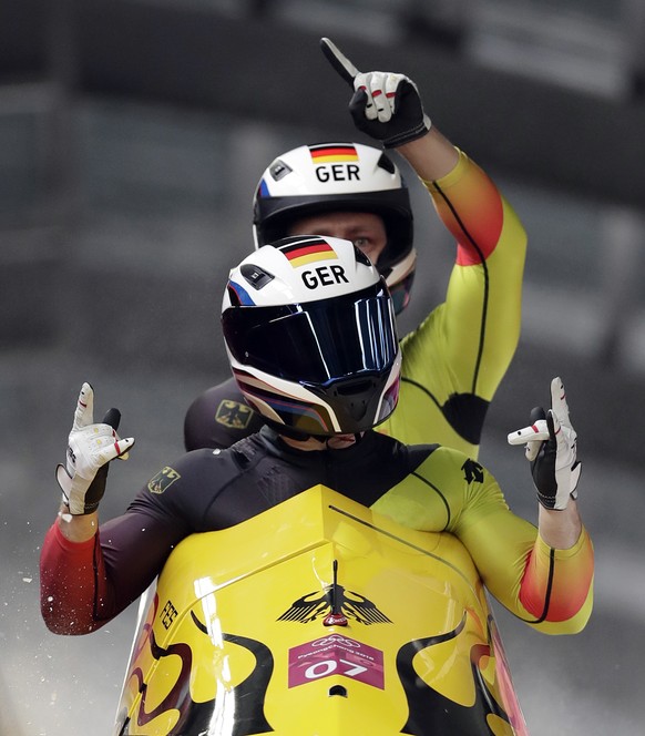 Driver Francesco Friedrich and Thorsten Margis of Germany celebrate after the final heat during the two-man bobsled final at the 2018 Winter Olympics in Pyeongchang, South Korea, Monday, Feb. 19, 2018 ...