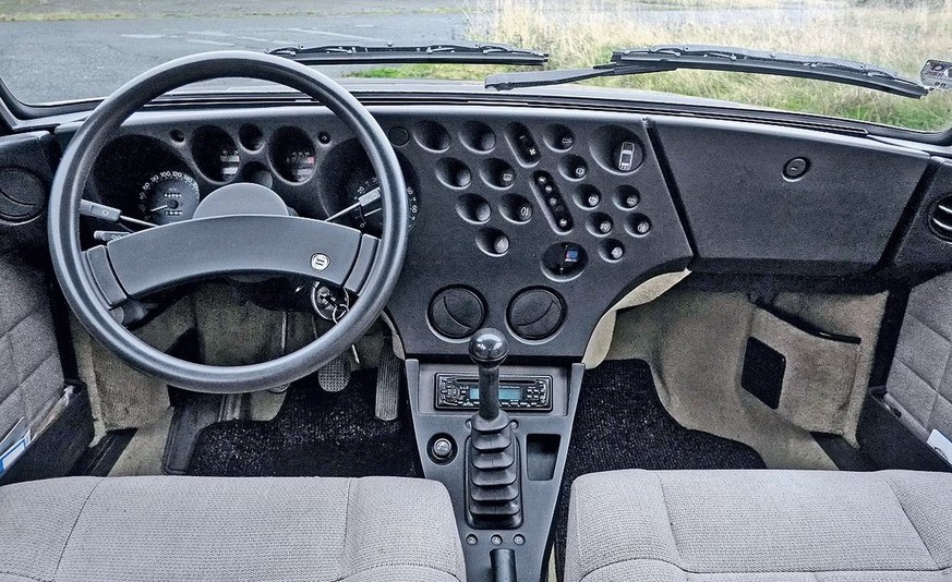 Lancia Beta Trevi - with the &quot;Swiss Cheese Dashboard&quot;.

https://en.wikipedia.org/wiki/Lancia_Trevi