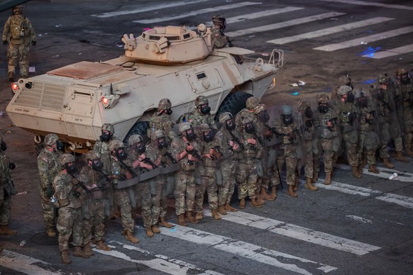 epa08461803 Members of the Georgia National Guard secure the street after clearing protesters after curfew during a demonstration over the arrest in Minnesota of George Floyd, who later died in police ...