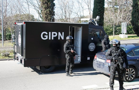 Elite police officers block the entrance of the Castellane housing project of Marseille, southern France, Monday, Feb.9, 2015. Police say gunmen have fired automatic weapons at the edge of a housing p ...