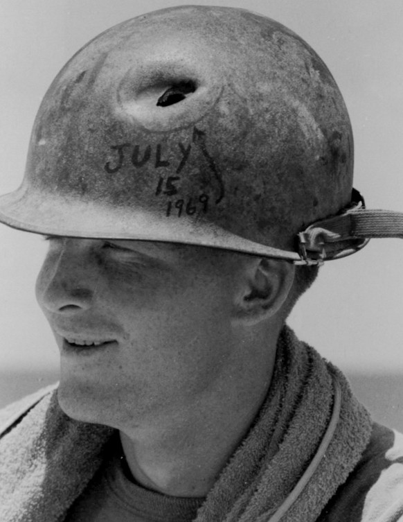 RECORD DATE NOT STATED A US Marine from the 1st Marine Division in the Vietnam War shows his helmet pierced by a bullet from a Viet Cong near miss. This photograph, taken on July 15, 1969, captures th ...