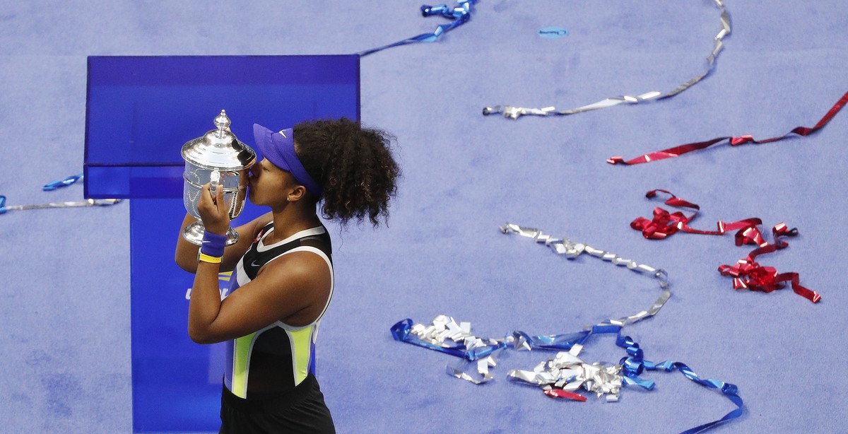 epa08665478 Naomi Osaka of Japan celebrates with the Championship Trophy after defeating Victoria Azarenka to win the Women's Final match on the thirteenth day of the US Open Tennis Championships ...