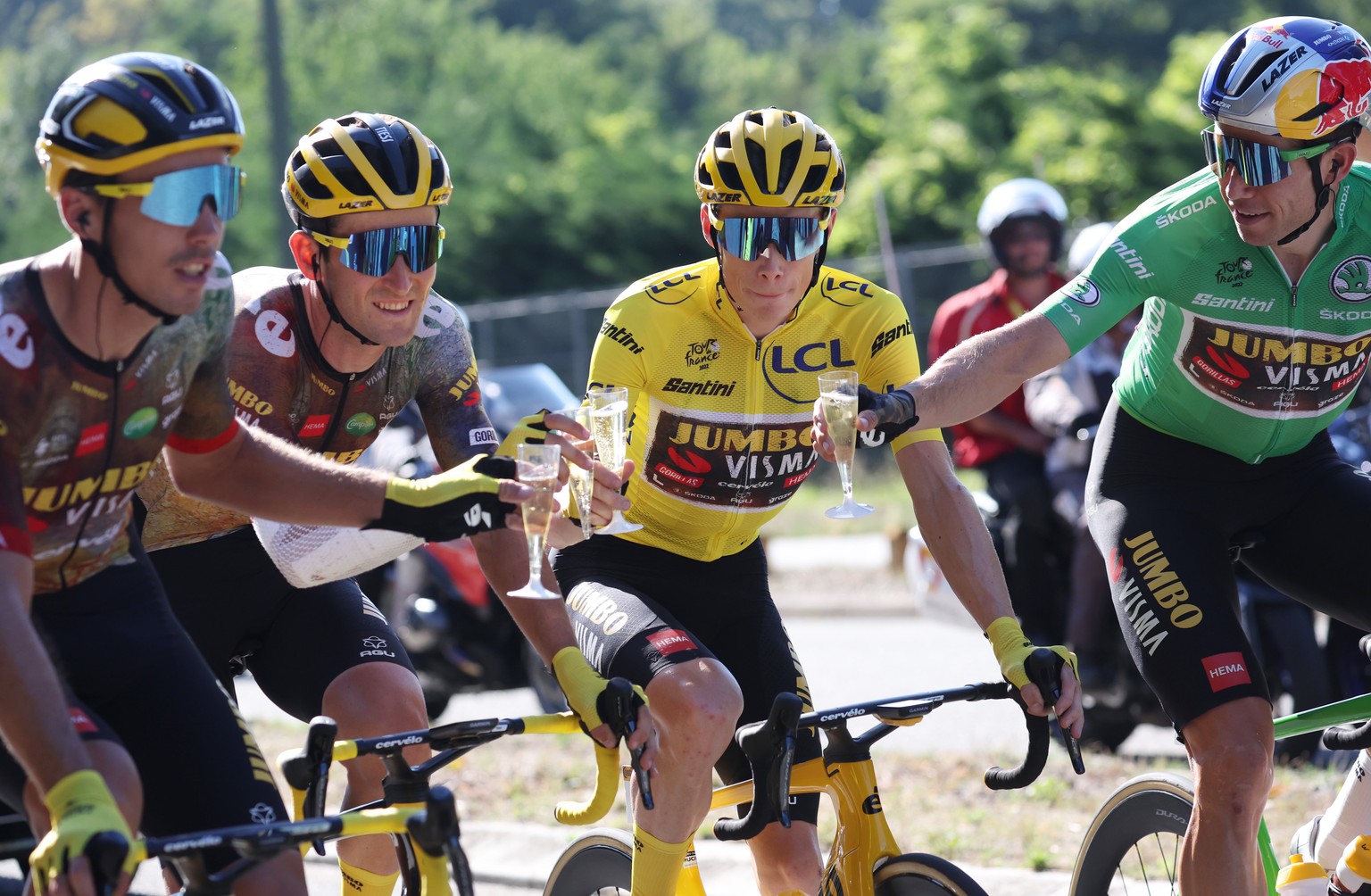 epa10089804 Jumbo Visma riders (L-R) French rider Christophe Laporte, Belgium rider Tiesj Benoot, the Yellow Jersey Danish rider Jonas Vingegaard and the Green Jersey Belgium rider Wout Van Aert toast ...