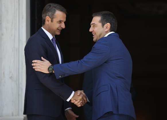 Greece&#039;s newly-elected prime minister Kyriakos Mitsotakis, left, ,shakes hands with outgoing prime minister Alexis Tsipras, right, as Tsipras leaves the Maximos Mansion in Athens, Monday, July 8, ...