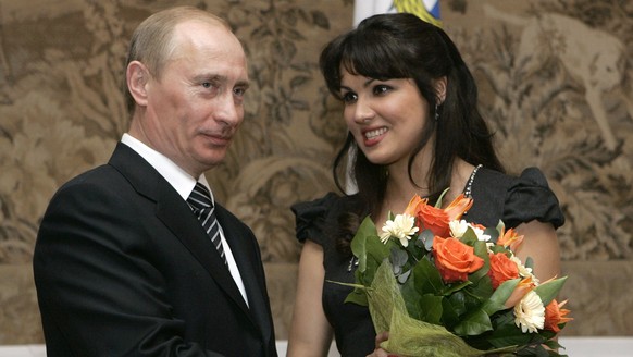 FILE - Russian President Vladimir Putin, left, congratulates Russian opera singer Anna Netrebko after awarding her with the People&#039;s Artist of Russia honor, during the 225th anniversary celebrati ...