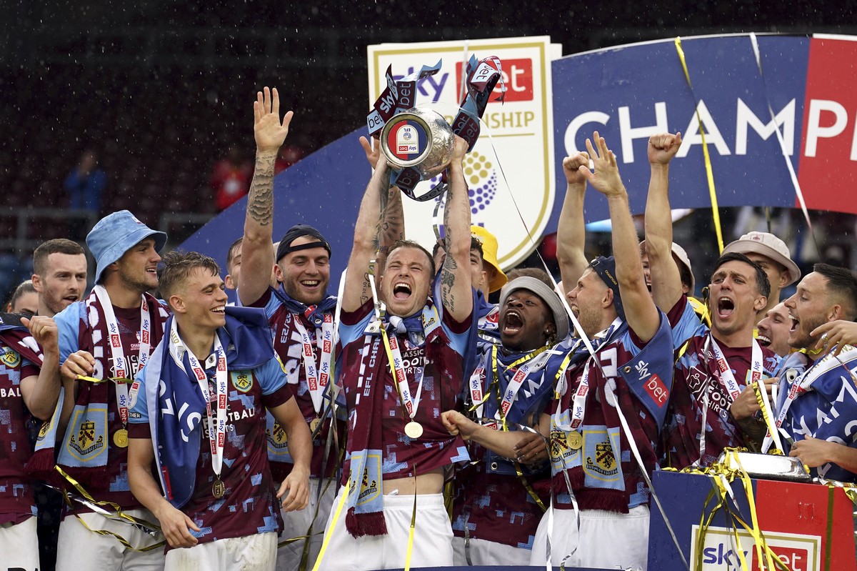 Burnley's Ashley Barnes lifts the trophy after the English Football League Championship soccer match against Cardiff City at Turf Moor, Burnley, England, Monday, May 8, 2023. (Martin Rickett/PA v ...