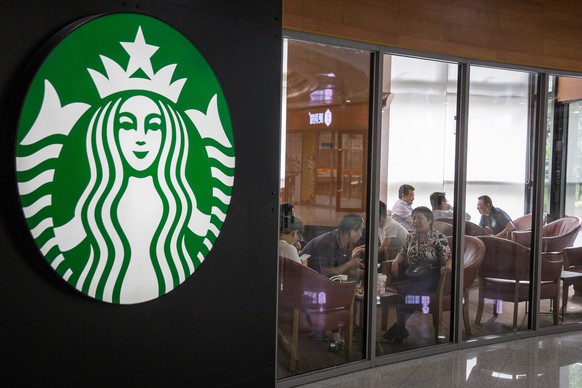 epa06764044 People have coffee at a branch of the American coffee chain Starbucks in Beijing, China, 23 May 2018 (issued 26 May 2018). Chinese coffee chain &#039;Luckin coffee&#039; has sued Starbucks ...