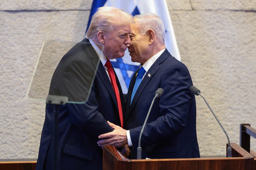 President Donald Trump talks with Israel&#039;s Prime Minister Benjamin Netanyahu at the Knesset, Israel&#039;s parliament, Monday, Oct. 13, 2025, in Jerusalem. (Evelyn Hockstein/Pool via AP)
Trump Mi ...