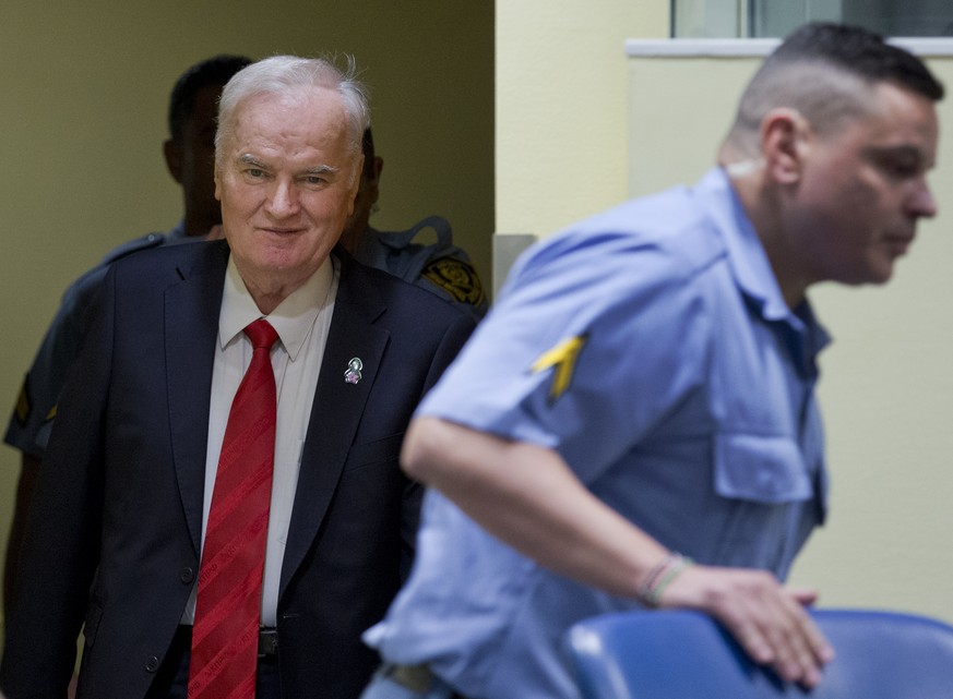 Bosnian Serb military chief Ratko Mladic, left, enters the Yugoslav War Crimes Tribunal in The Hague, Netherlands, Wednesday, Nov. 22, 2017, to hear the verdict in his genocide trial. Mladic&#039;s tr ...