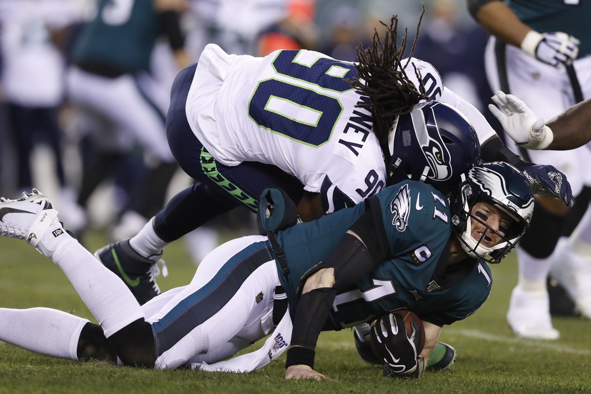 Seattle Seahawks' Jadeveon Clowney (90) hits Philadelphia Eagles' Carson Wentz (11) during the first half of an NFL wild-card playoff football game, Sunday, Jan. 5, 2020, in Philadelphia. We ...