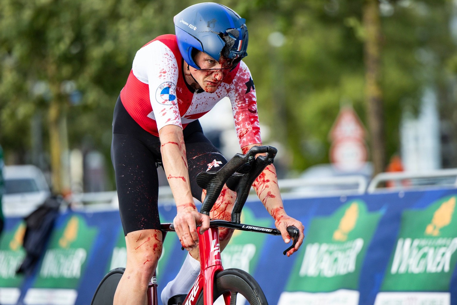 Swiss Stefan Kung of Groupama-FDJ pictured with blood on his white sleeve and face, and a broken helmet, after a heavy fall during the elite men individual time trial at the UEC Road European Champion ...