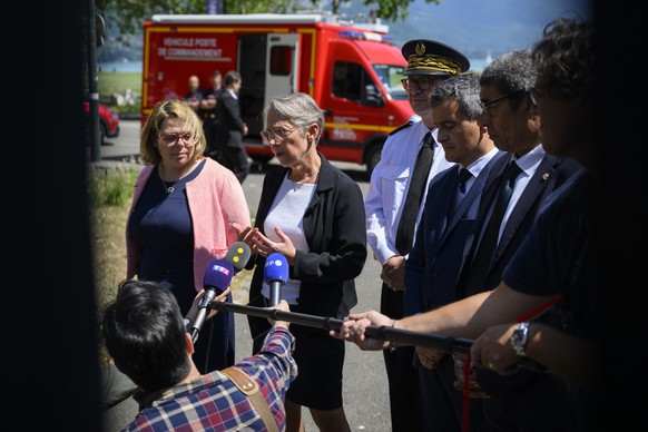 French Prime Minister Elisabeth Borne, center, French Interior and Overseas Minister Gerald Darmanin, right, and Line Bonnet-Mathis, left, prosecutor in Annecy speak to the press after a knife attack ...