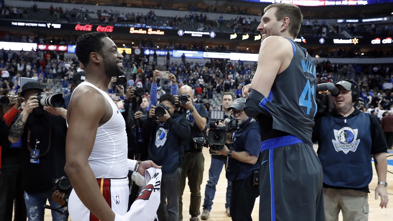 Miami Heat&#039;s Dwyane Wade, left, and Dallas Mavericks&#039; Dirk Nowitzki, right, talk as they swap jerseys after an NBA basketball game in Dallas, Wednesday, Feb. 13, 2019. (AP Photo/Tony Gutierr ...