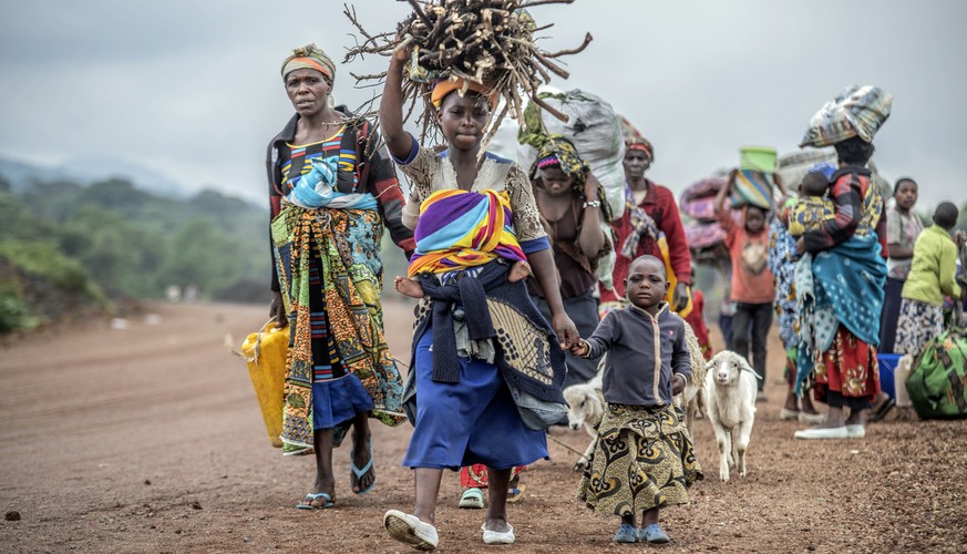 Residents flee fighting between M23 rebels and Congolese forces near Kibumba, some 20 kms ( 12 miles) North of Goma, Democratic republic of Congo, Saturday Oct. 29, 2022. Hundreds have been killed and ...